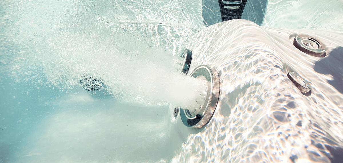 MasterSpas bluetooth speaker placed on top of the output of a waterfall feature on a hot tub.