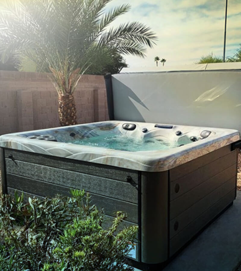 At-Home Tropical Getaway. Lush plants add color, shade, and privacy to this cozy backyard hot tub installation.